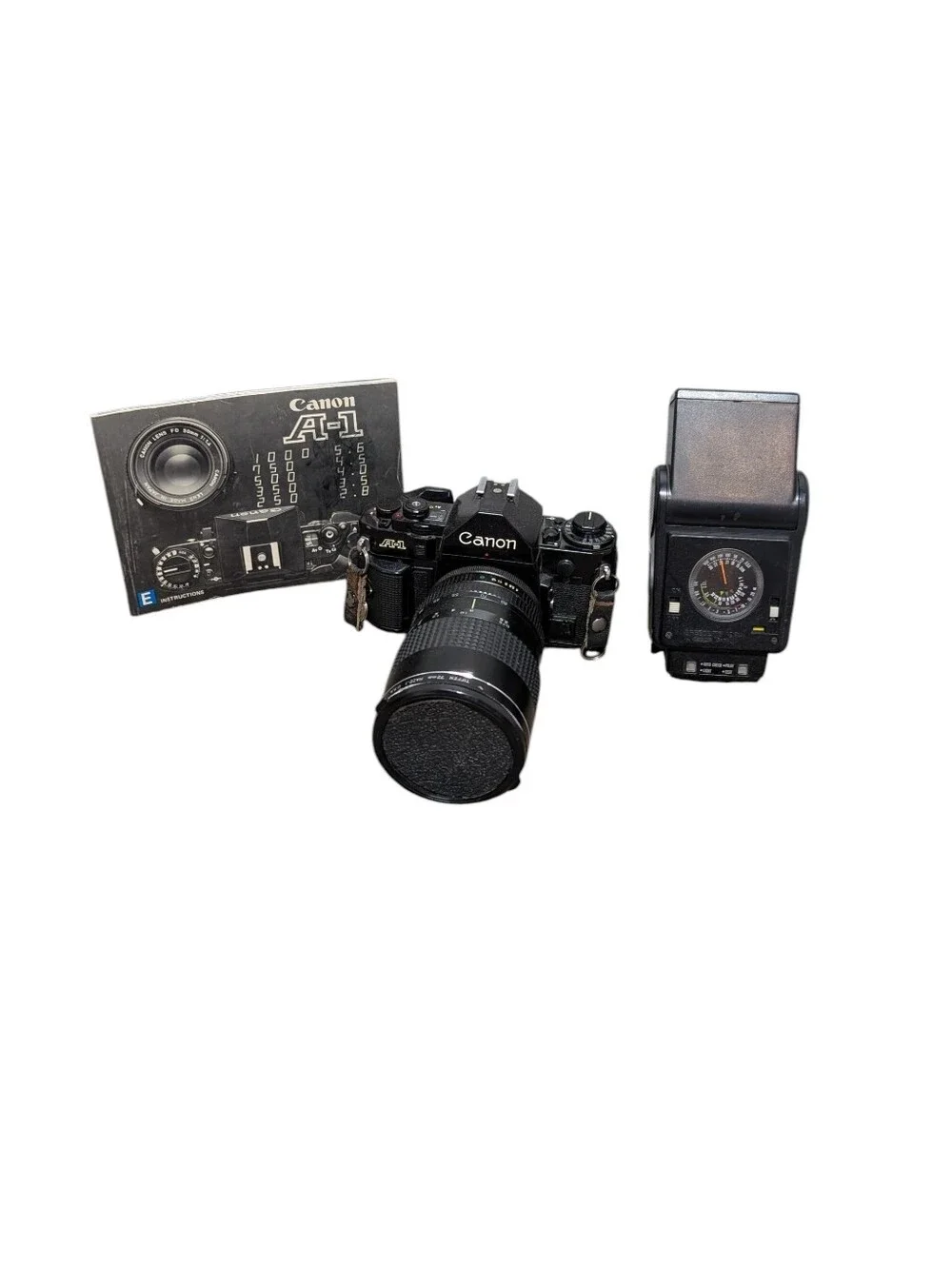 Vintage Canon A-1 Black SLR Camera with Black Lens and Black Flash